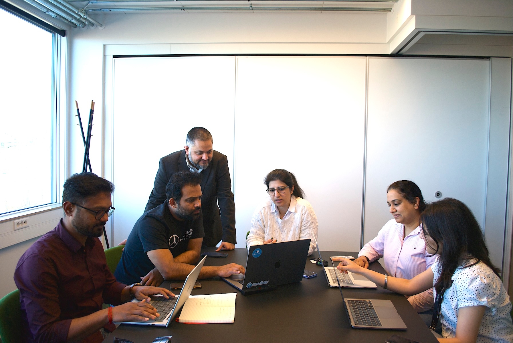 Team working around laptop