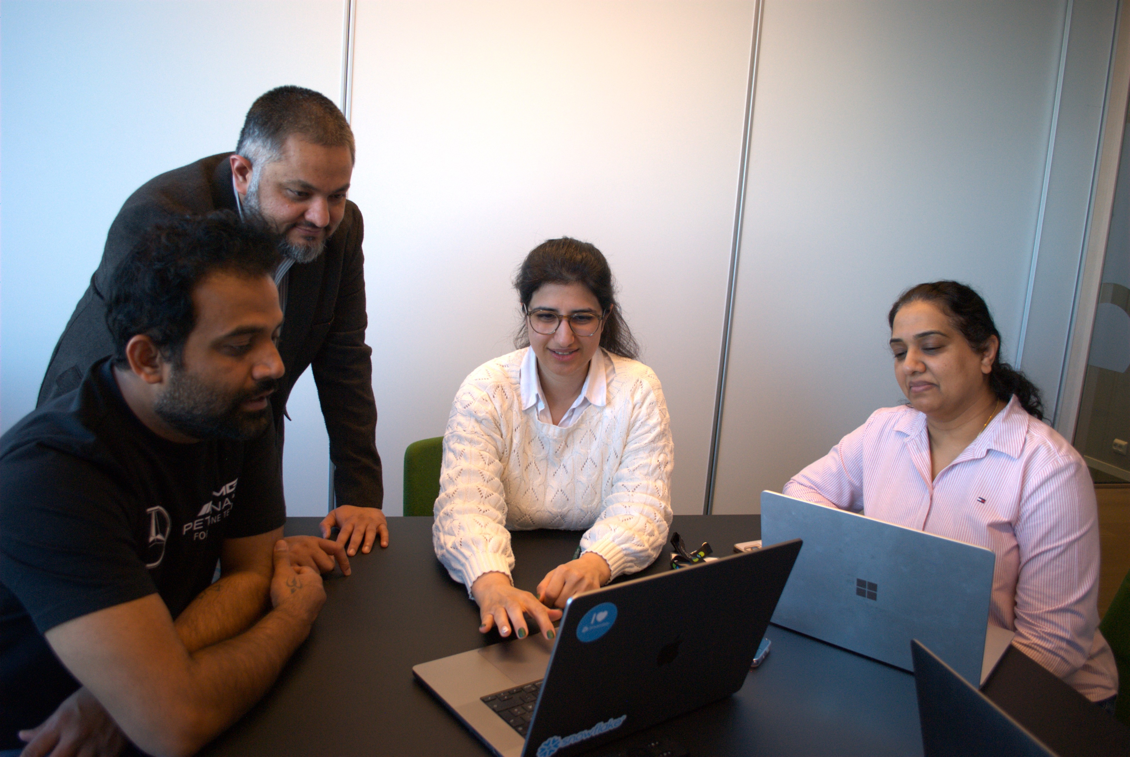 Team around laptop